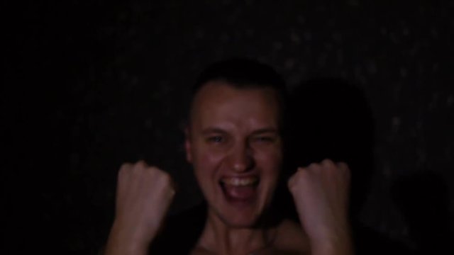 Young man madel, athletic figure, black background