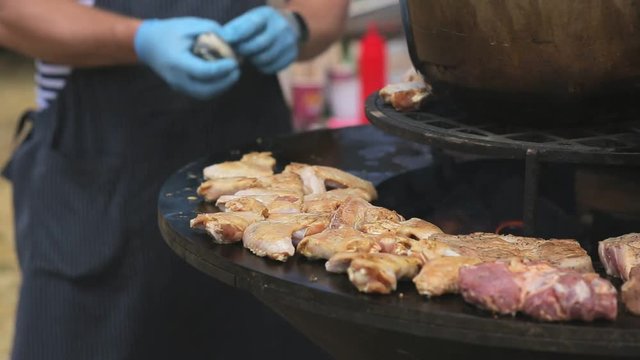 Process of cooking meat and chicken on the large grill