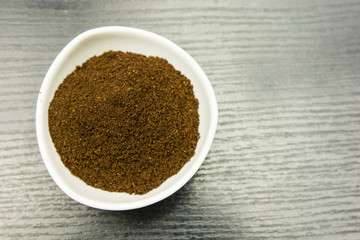 Ground coffee in a white bowl. View from above.