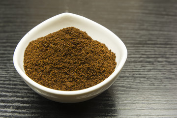 Ground coffee in a white bowl.