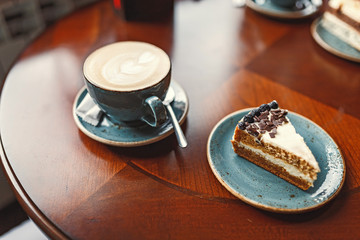 Chocolate cake on the plate and cup of coffee