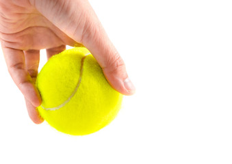 left hand holding new yellow tennis ball on white background, ready to serve position, copy space on right