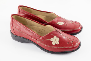 Female red leather shoe on white background, isolated product, footwear.