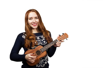 Fototapeta premium Red-haired girl play on the ukulele isolated on white. 