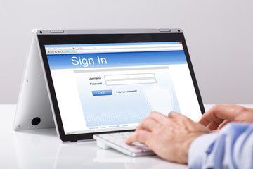Close-up Of Businessman Using Digital Tablet For Signing In