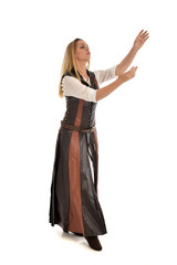 Fototapeta premium full length portrait of girl wearing brown fantasy costume. standing pose on white studio background. 