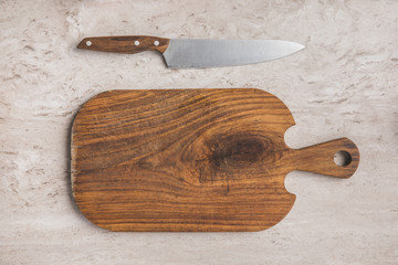top view of empty cutting board and knife on marble table
