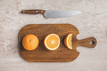 top view of ripe oranges on cutting board