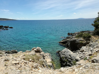 Fototapeta na wymiar Hrvatian Porec rocky beach of Medditerean sea