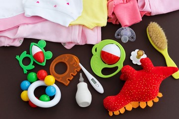 Baby clothes and accessories on dark background. Newborn background.