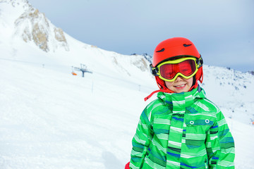 Skier boy in a winter ski resort.