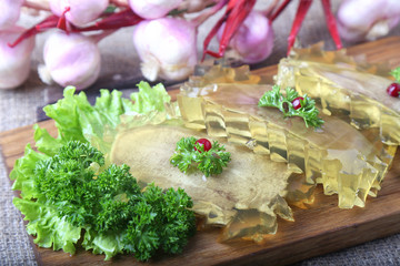 Tasty jellied beef tongue on wooden board