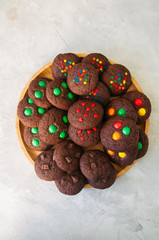 Set of chocolate cookies with different decorations on a white stone background. Copy space.