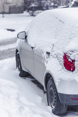 Cars covered with snow. Winter weather. Congestion on the roads.