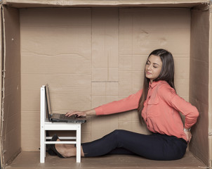 business woman sitting in the office box and is struggling with back pain