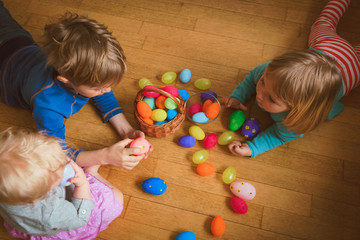 Fototapeta na wymiar little boy and girl play with easter eggs