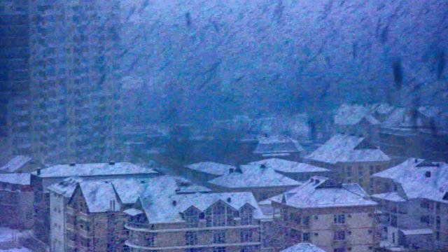 Incredibly thick and large its snowing over city

