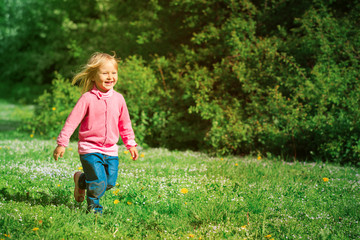 happy little girl run play in spring nature