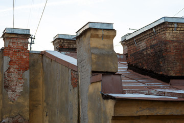 Old brick chimneys on tin roof.