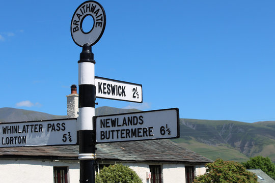 Braithwaite signpost for Keswick, with Skiddaw fell behind. Cumbria, UK. 
