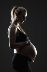 Pregnant Blond Woman in Black Bra.