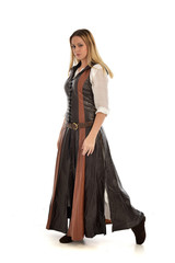 full length portrait of girl wearing brown  fantasy costume. standing pose on white studio background. 