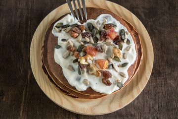 Pancake with cream and nuts . Close-up photo detail.Healthy breakfast