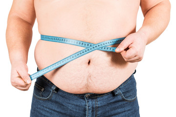 Man measuring his fat belly with measurement tape
