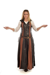 Fototapeta premium full length portrait of girl wearing brown fantasy costume. standing pose on white studio background. 
