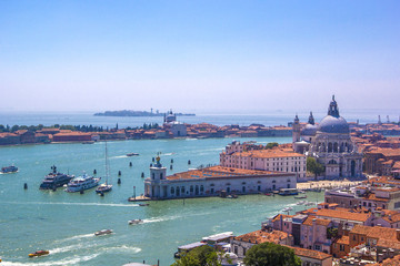 Fototapeta na wymiar Panorama of Italian houses with red tiled roofs, Adriatic sea and Grand Canal with boats and gondolas, ships and boats, romantic city on water, Venice, Italy. Top view.