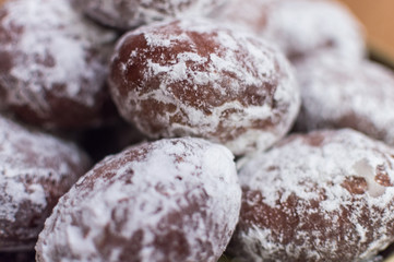 Fresh baked homemade donuts with powdered sugar on them - close up