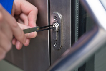 Fototapeta premium Person Opening Door With Lockpicker