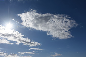 Naklejka na ściany i meble 青空と雲「空想・雲のモンスター(太陽に近づきすぎて顔がとけ出したモンスターなどのイメージ）」（熱い、暑い、熱中症、顔をしかめる、ゆがめるなどのイメージ）