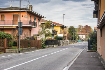 Empty road through residential area in Italy, Europe early in the morning.