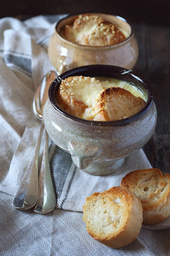 French onions soup with baguette. Rustic style