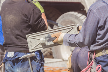 Construction workers pouring cement from the mixer truck.