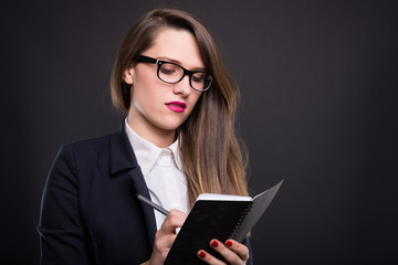 Attractive successful woman writing notes
