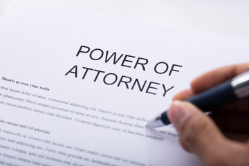 Person Filling Power Of Attorney Form