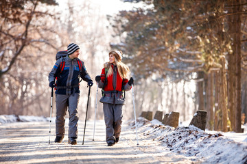 Couple of hikers walking and talking in nature