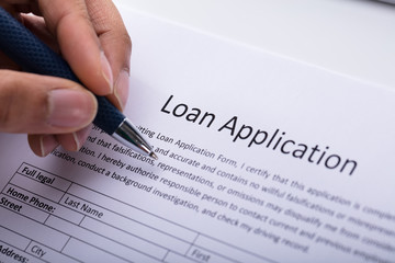 Person Filling Loan Application Form