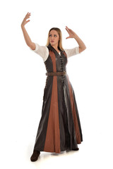 Fototapeta premium full length portrait of girl wearing brown fantasy costume. standing pose on white studio background. 