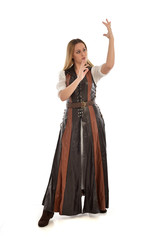 Fototapeta premium full length portrait of girl wearing brown fantasy costume. standing pose on white studio background. 