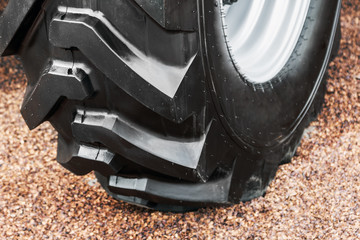 big tyre of a tractor or bulldozer. The details of the construction or repair of equipment