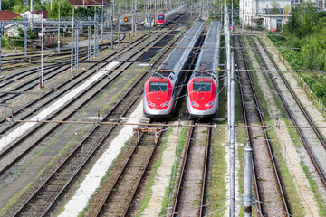 railways, high-speed trains: two trains on tracks ready to travel and transport passengers for economic activities and tourism.