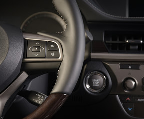 Obraz na płótnie Canvas media control buttons on the steering wheel, modern luxury car interior details
