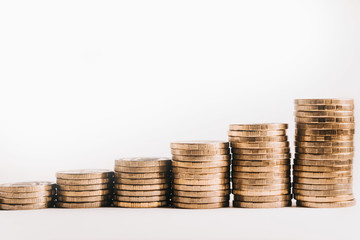 Pile of gold coins, ascending. Isolated white background.