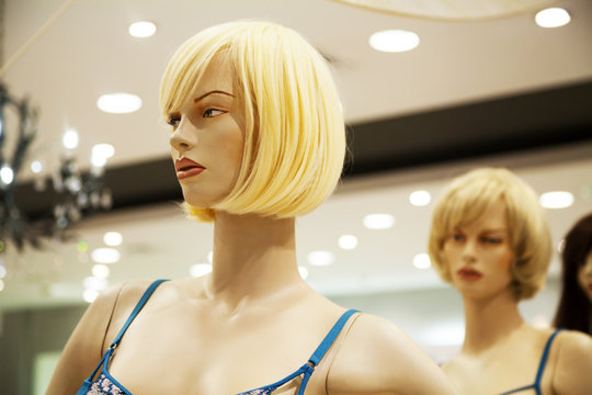 Two Glamour Blonde Mannequins In A Shopping Mall. Cruel Bitchy Friend Hatching Up Revenge Behind Your Back