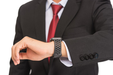 Close up of a man in black suit see at watch on his hand with white background