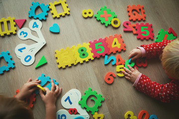 kids play with number puzzle, learning math