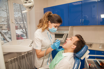 A woman doctor dentist in the office communicates with the patient. Stomatology. Medicine.